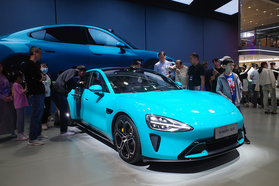 Attendees of the Beijing International Automotive Exhibition check out Xiaomi's EVs on May 3. Photo: VCG